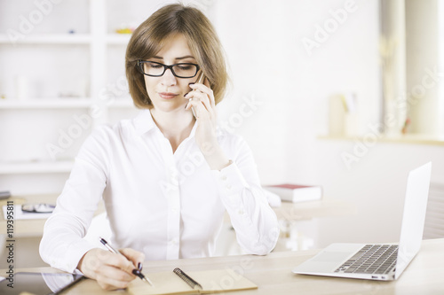 Woman on phone writing © peshkova