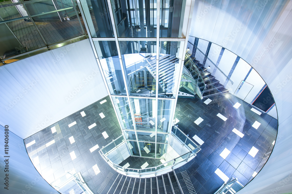 Fototapeta premium glass sighseeing lift with spinning staircase