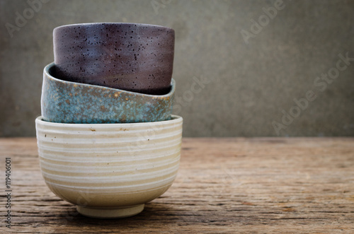 Leinwand Poster Empty bowl on rustic wood, Japanese handmade ceramic bowl,  ceramic texture