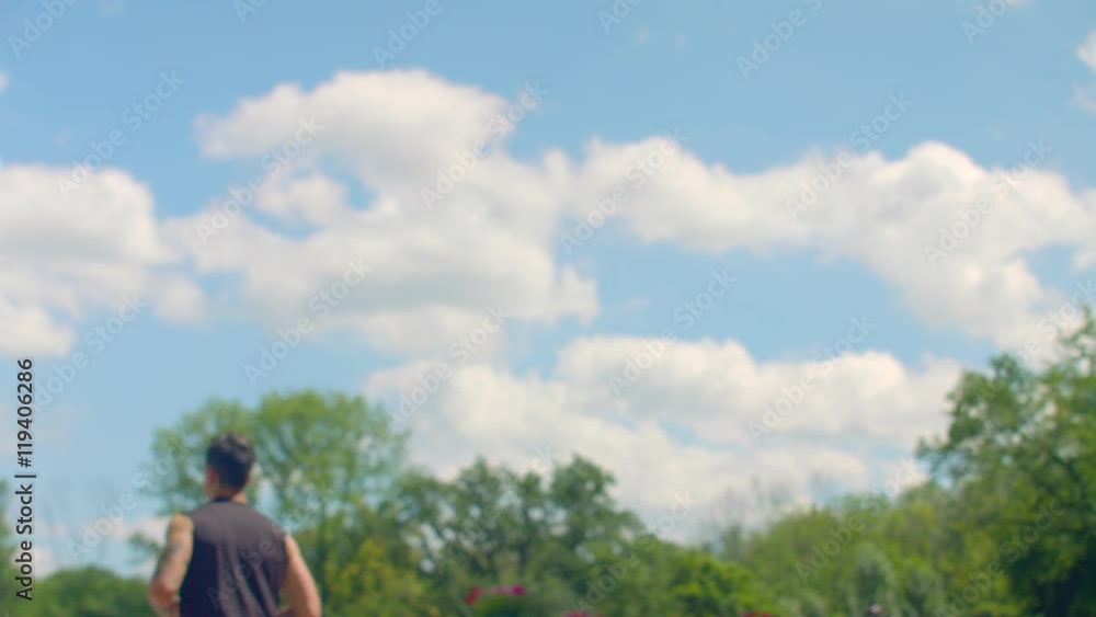 Young man runs outdoor in slow motion. Man running on background of sky. Handsome male runner training at summer. Fit man runs on cloud sky background. Workout outdoor. Healthy lifestyle concept Young man runs outdoor in slow motion. Man running on background of sky. Handsome male runner training at summer. Fit man runs on cloud sky background. Workout outdoor. Healthy lifestyle concept