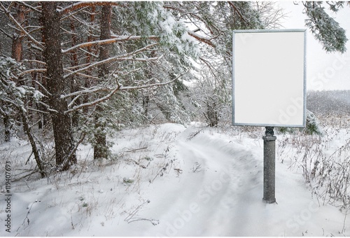 empty billboard for advertising on background snowy forest landscape