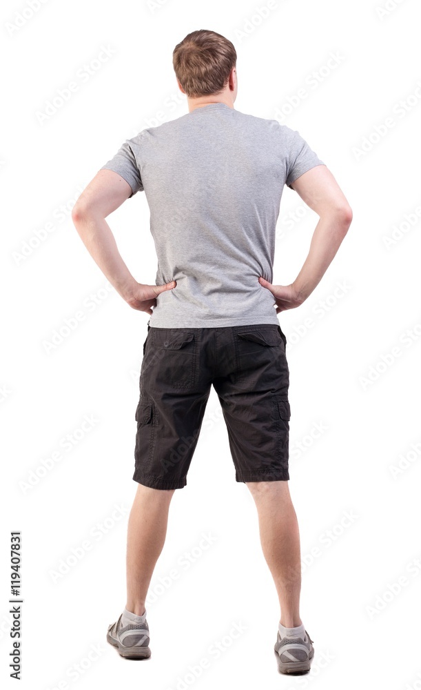 Back view of handsome man in t-shirt and shorts looking up. Standing young tourist. Rear view people collection. backside view of person. Isolated over white background. athlete demonstrates his Back view of handsome man in t-shirt and shorts looking up. Standing young tourist. Rear view people collection. backside view of person. Isolated over white background. athlete demonstrates his