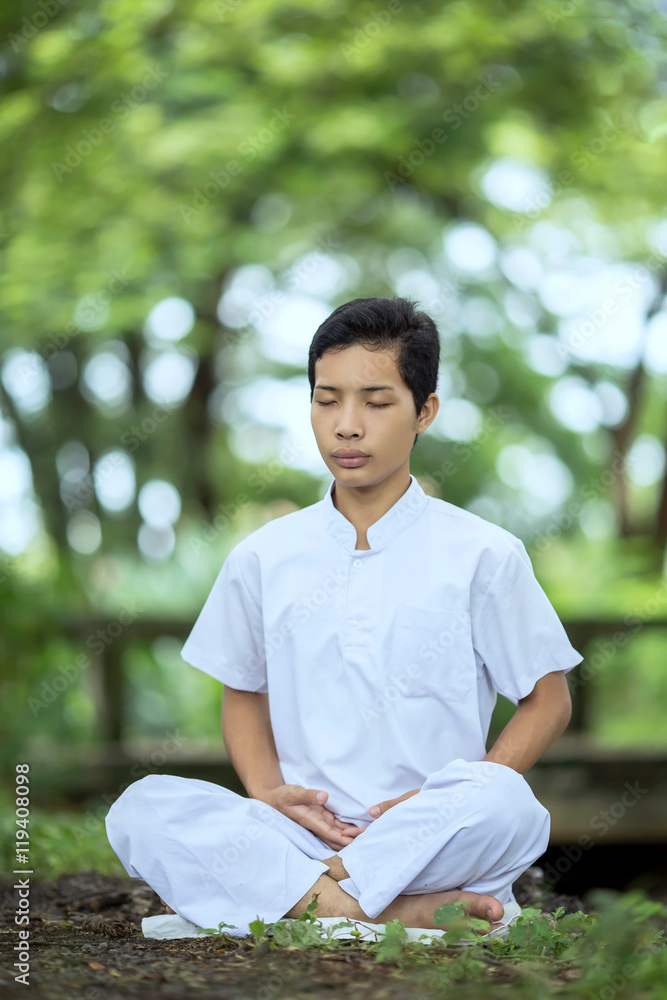 Male Asian Buddhist meditation seats near the brook. Male Asian Buddhist meditation seats near the brook.