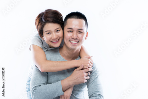 Young and happy Asian couple looking at the camera.