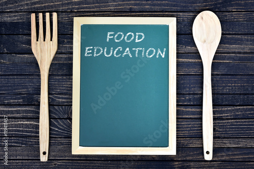 Food Education text on green board with fork and spoon