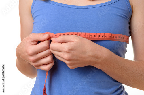 Obraz na plátně Young woman measuring her breasts