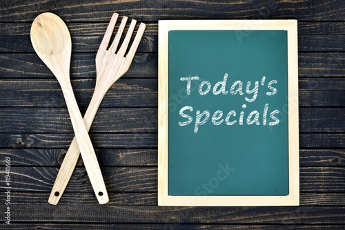 Fototapeta Today's Specials text on green board with fork and spoon
