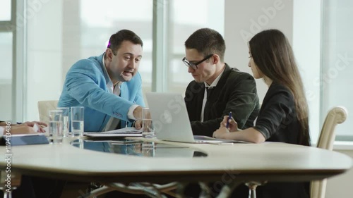angry businessman shouts at his team