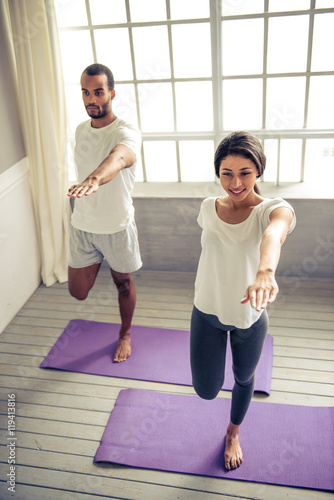 Afro American couple doing yoga