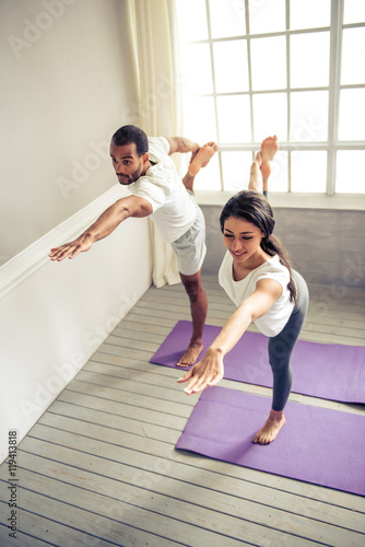Afro American couple doing yoga