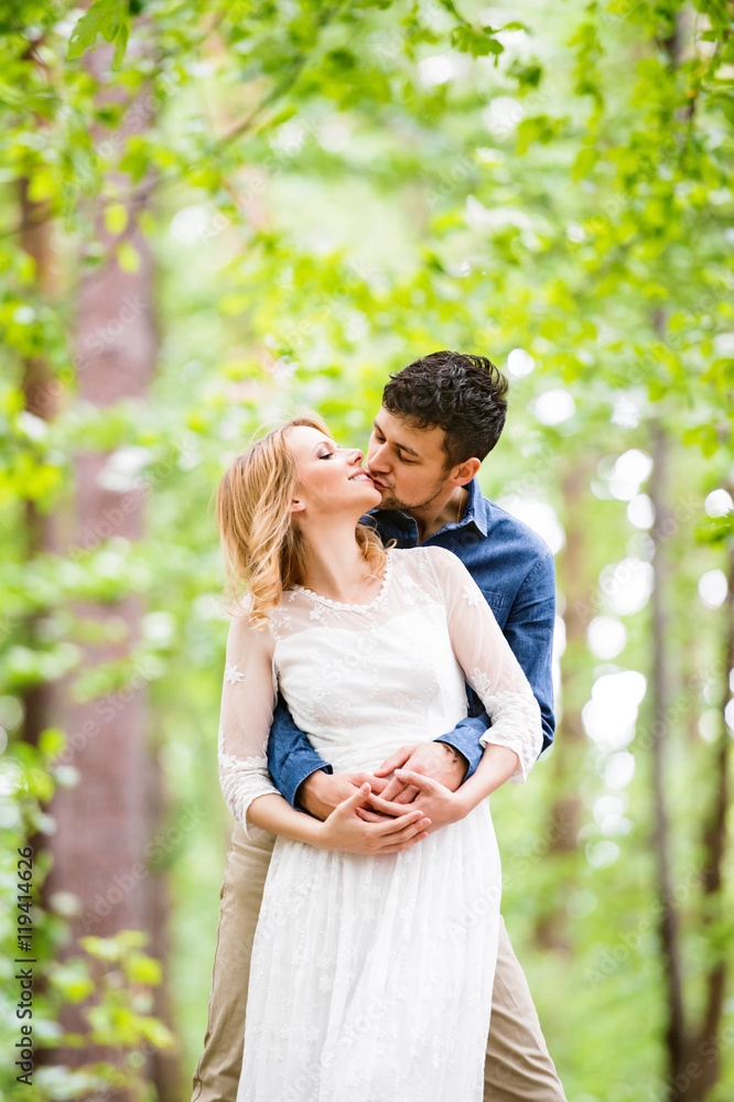 Beautiful wedding couple outside in green forest. Beautiful wedding couple outside in green forest.