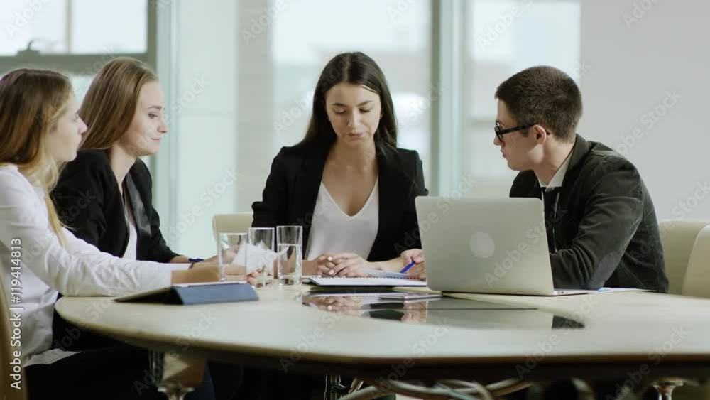 woman answeres a phone call during the business meeting woman answeres a phone call during the business meeting