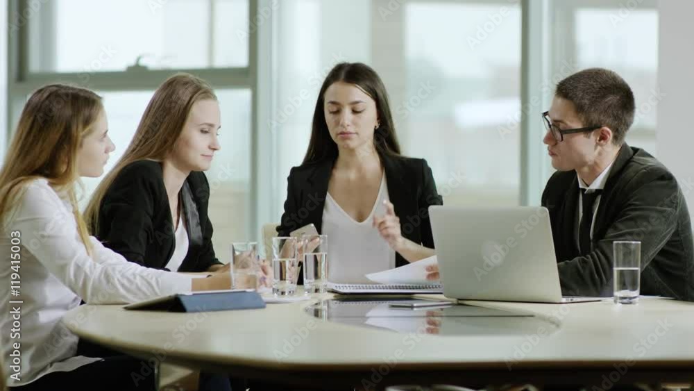 female boss talking on phone during the meeting female boss talking on phone during the meeting