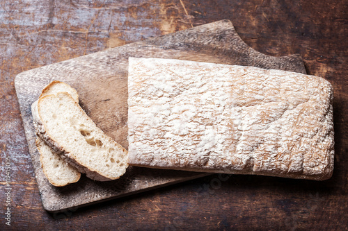 Fresh bread on wooden background. White baked bread on a wooden