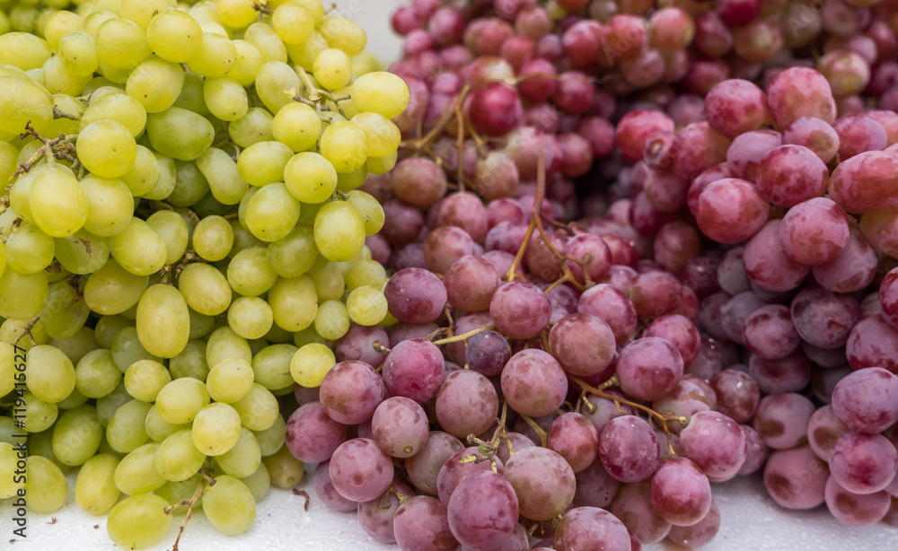 Green-yellow and red grapes for sale at city farmers market