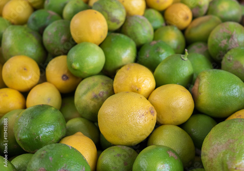 Fresh yellow and green lemons at the city market