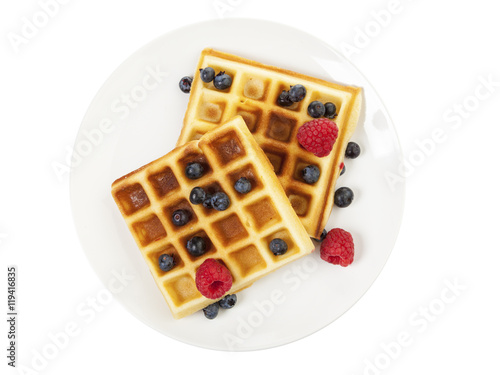 Handmade waffles with berry fruit on plate isolated on white