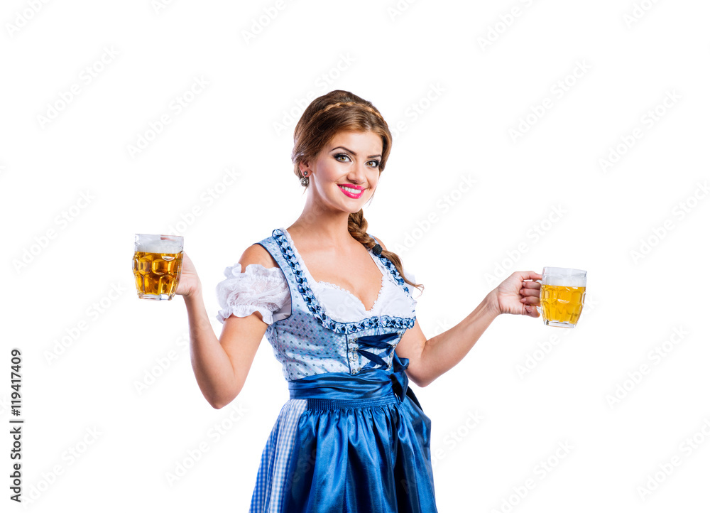 Woman in traditional bavarian dress holding mugs of beer Woman in traditional bavarian dress holding mugs of beer