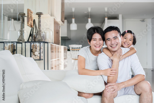 Young and happy Asian family at home.