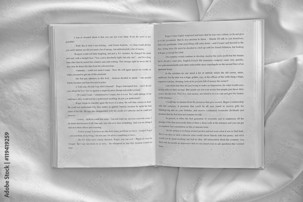 Fototapeta premium Opened book on white crumpled sheet