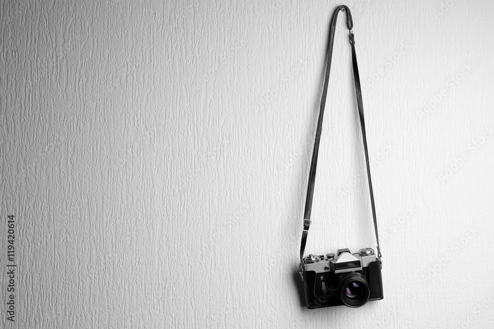 Vintage camera hanging on white textured background Stock Photo Adobe Stock