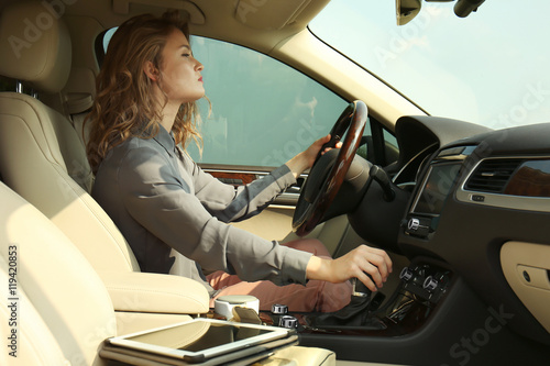 Pretty young woman driving car