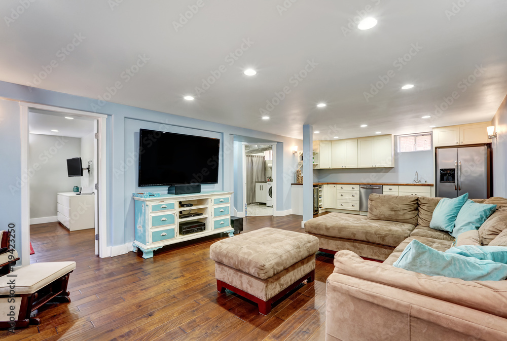 Fototapeta premium Pastel blue walls in basement living room interior.