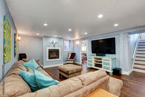 Pastel blue walls in basement living room interior. photo