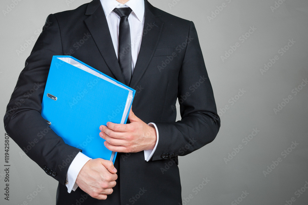 Confident businessman holding a document folder Confident businessman holding a document folder