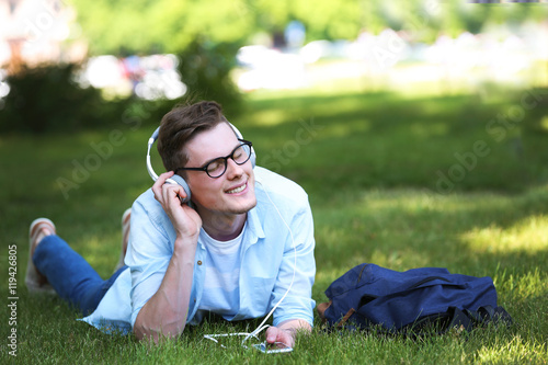 Handsome man lying on grass...