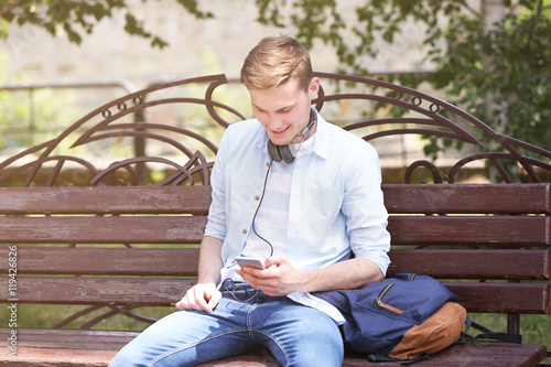 Handsome man listening musi...