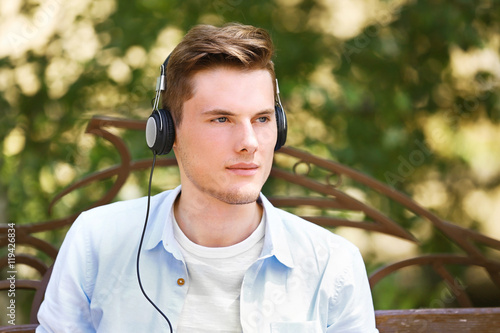 Handsome man listening musi...
