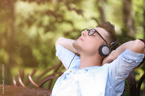 Handsome man listening musi...