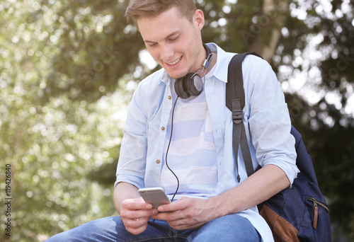 Handsome man listening musi...