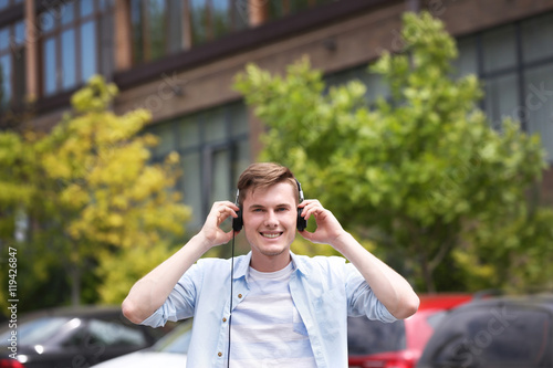 Handsome man listening musi...