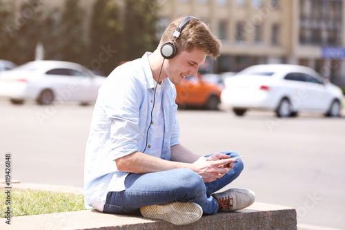 Handsome man listening musi...