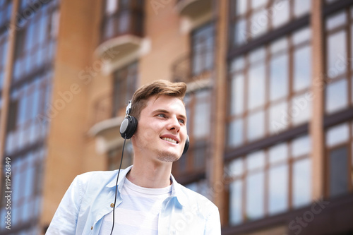 Handsome man listening musi...