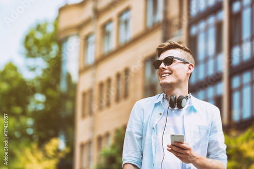 Handsome man listening musi...