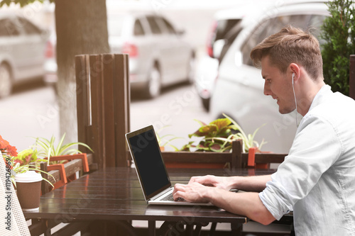 Handsome man with laptop li...