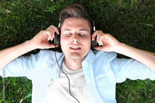 Handsome man listening musi...