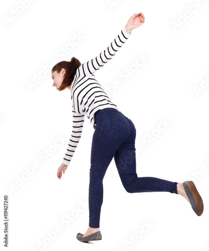Balancing young woman. or dodge falling woman. Girl in a striped sweater slipped down.