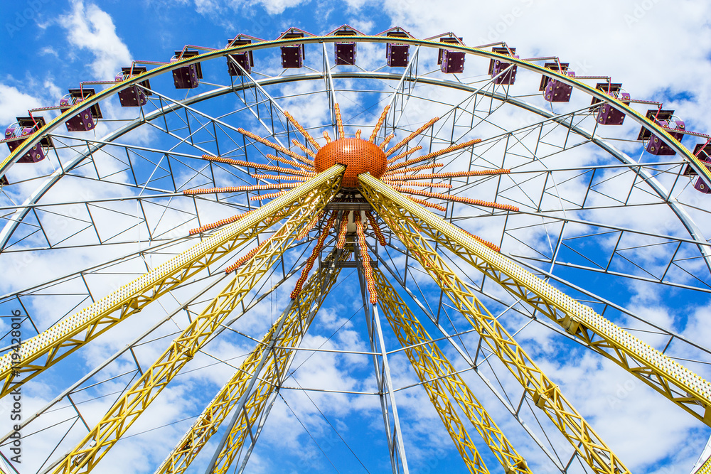 The Ferris wheel on the background of the cloudy sky The Ferris wheel on the background of the cloudy sky