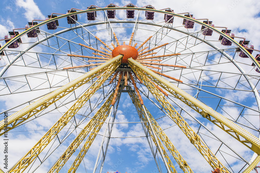 The Ferris wheel on the background of the cloudy sky The Ferris wheel on the background of the cloudy sky