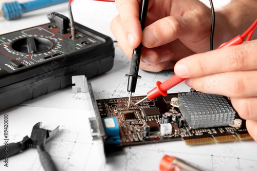 Man repairing video card, closeup