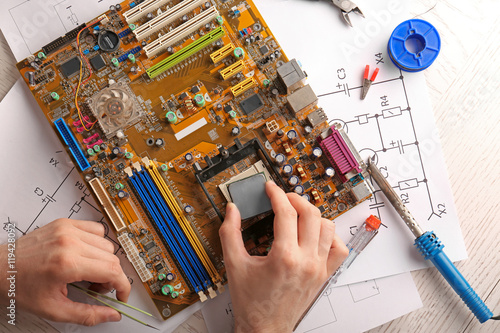 Man repairing motherboard, ...