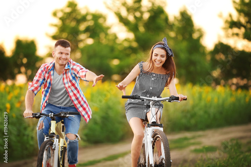 Young couple on bicycles in...