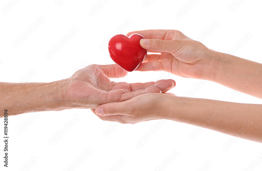 Fototapeta premium Old male and young female hands with heart figure on white background
