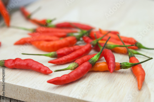 Red chili Peppers on wood chopping background