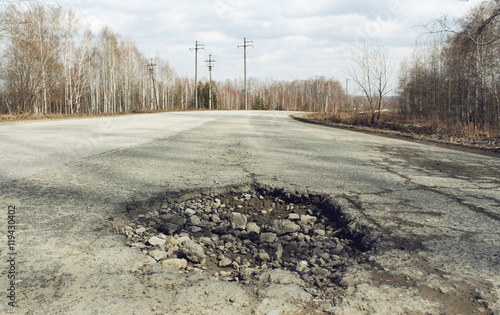 Wallpaper Mural Large road pothole on the old suburban broken road Torontodigital.ca