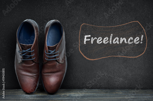 Freelance text on black board and business shoes